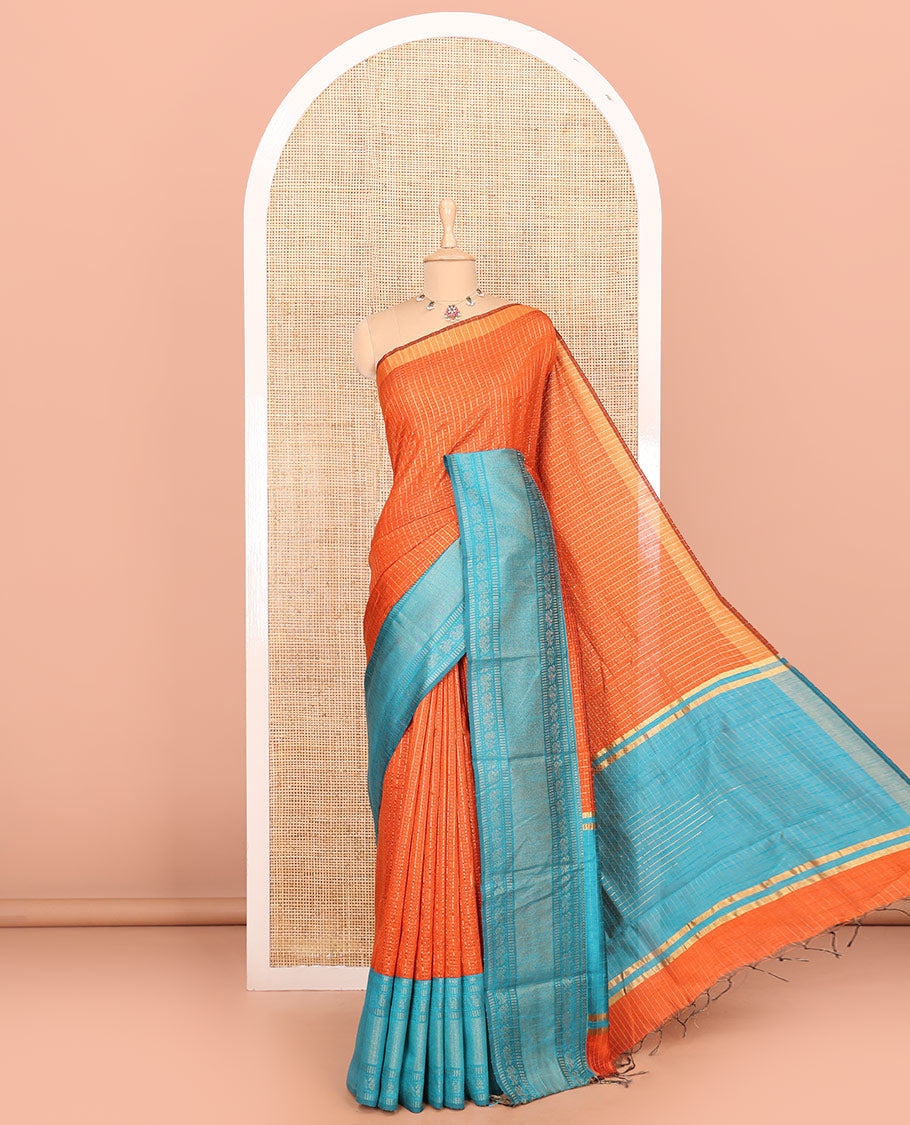 Rust orange zari dot enclosed checked semi-raw silk saree, contrast traditional zari design border, contrast diamond patterned pallu, and a contrast blouse