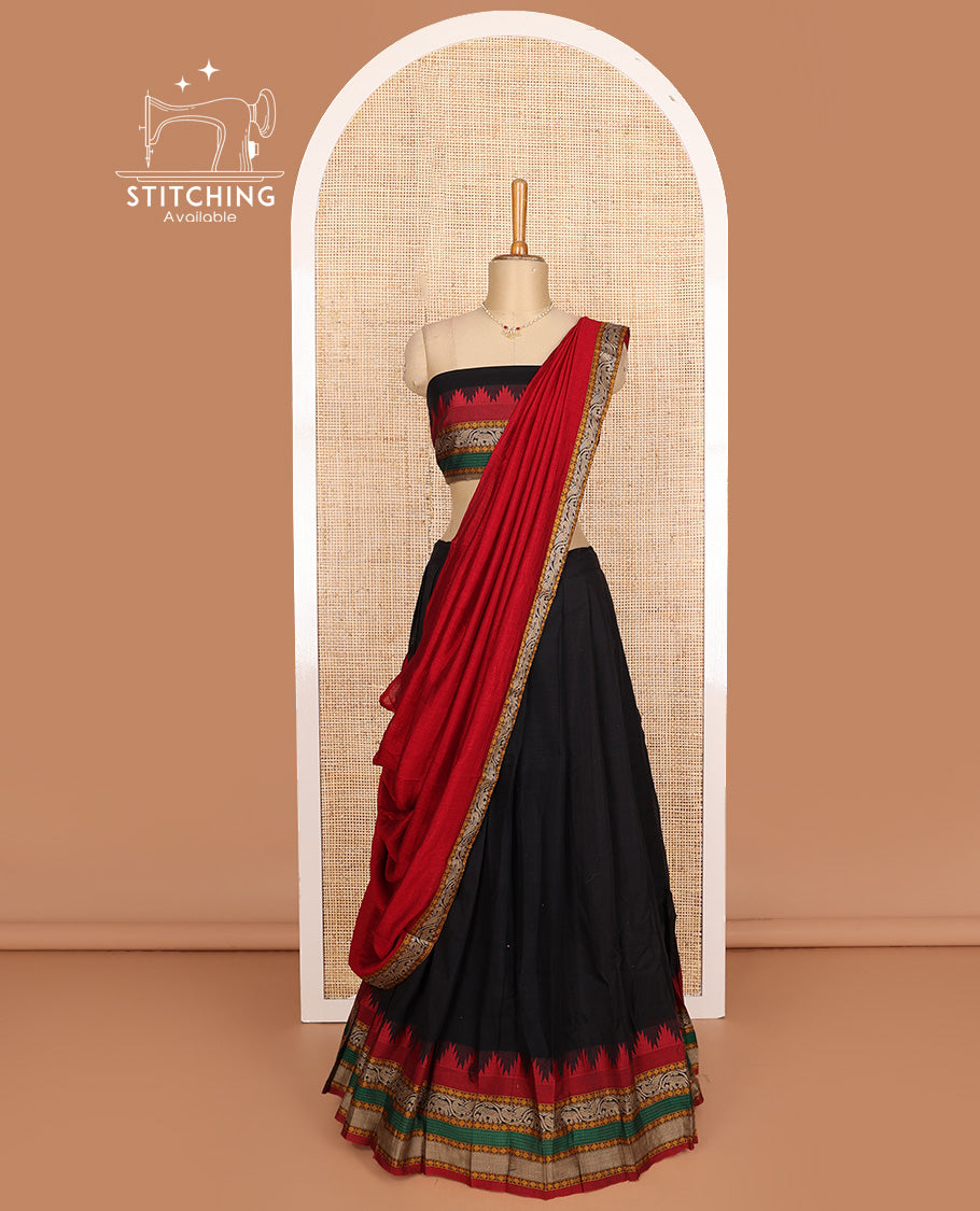 Black cotton half-saree, plain with contrast traditional motif bordered skirt, matching blouse, and contrast elephant motif dhavani