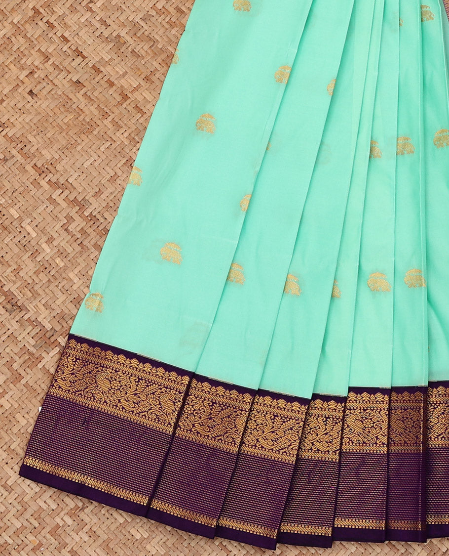 Turquoise Budget Silk Saree, Highlighted with Elephant Buttas All Over Its Body, Complemented by a Contrast Traditional Zari Design Border of Peacocks, Artfully Woven Pallu of Jaal Designs, and Paired with a Contrast Blouse