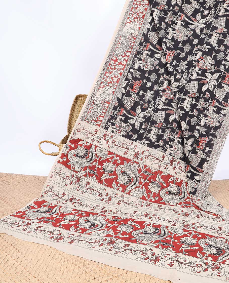 Black village theme machine-printed kalamkari cotton saree, contrast peacock border & intricate pallu