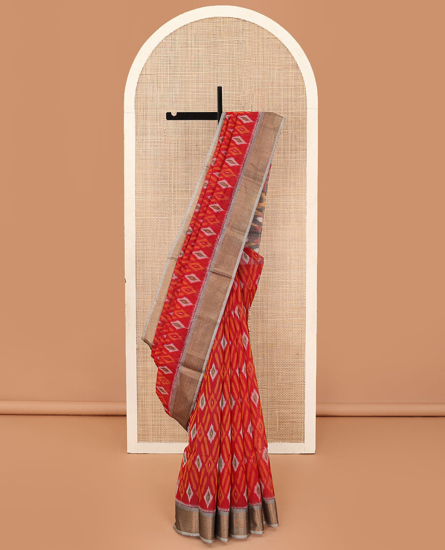 Red buttas and diamond patterned silk cotton saree, contrast bavanji border, and pallu of ikkat floral design