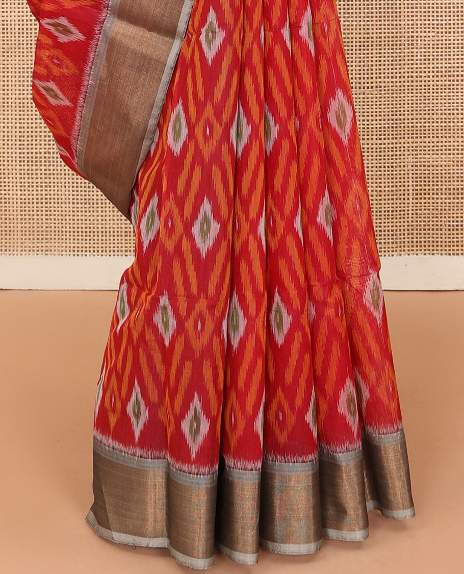 Red buttas and diamond patterned silk cotton saree, contrast bavanji border, and pallu of ikkat floral design