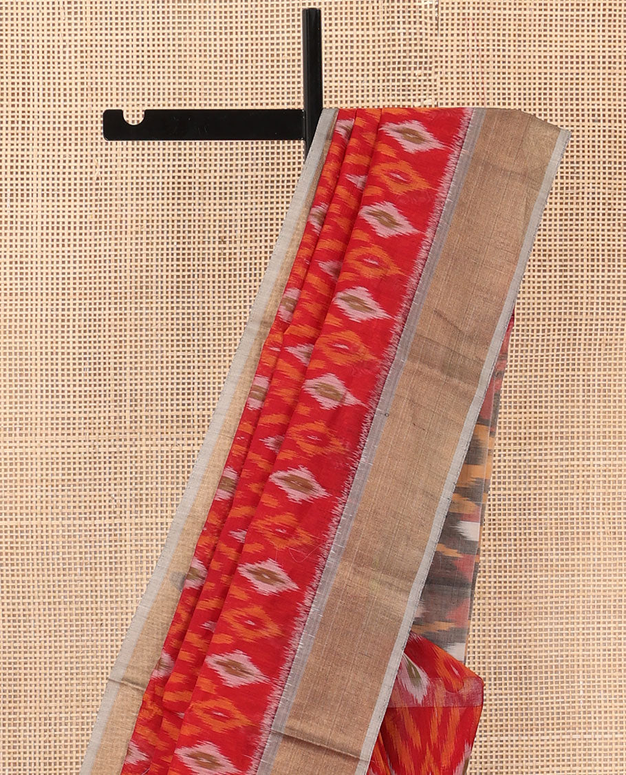 Red buttas and diamond patterned silk cotton saree, contrast bavanji border, and pallu of ikkat floral design