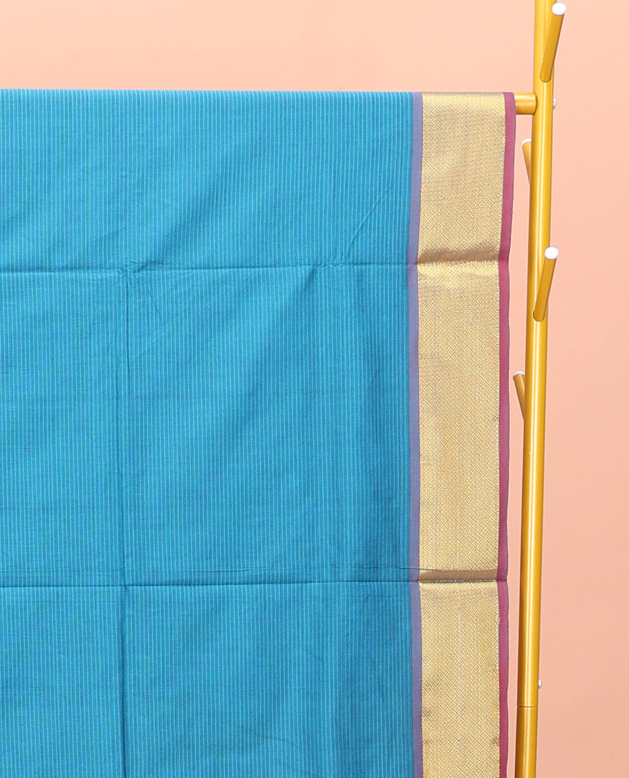 Blue Poly Cotton Saree, Sparsely Threaded with Stripes on Its Body, Complemented by Contrast Peacock-Eyed Border, Striped Pallu, and Paired with a Contrast Blouse