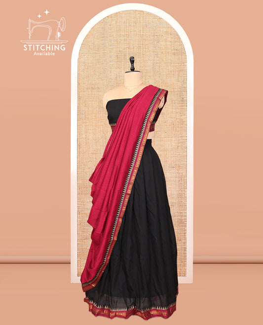 Black Cotton Half-Saree Features Plain Skirt, a Contrast Traditional Border, a Matching Blouse, and a Contrast Dhavani