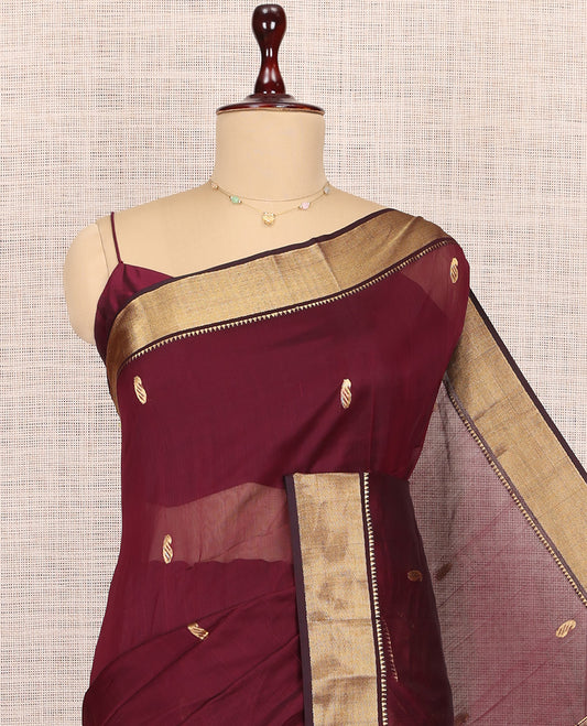 Maroon Maheshwari Cotton Saree, Adorned with Buttas, Highlighted by a Traditional Zari Border, Pallu Gleamed Up with Zari Buttas, and a Matching Blouse