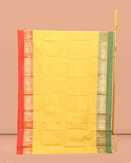 Yellow Chettinad Cotton Saree, Subtly Sparkled with Buttas All Over Its Body, Complemented by a Contrast Ganga-Jamuna Kal Eragina Border of Kodi Peacock and Elephant Designs, Pallu of Buttas and Stripes, and Paired with a Matching Blouse