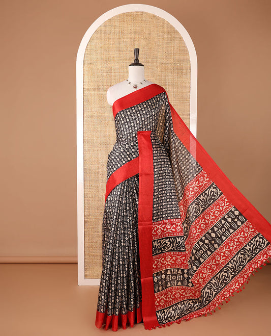 Black batik-style geometric motifs block printed khadi cotton saree,contrast border, batik floral print pallu & plain red blouse
