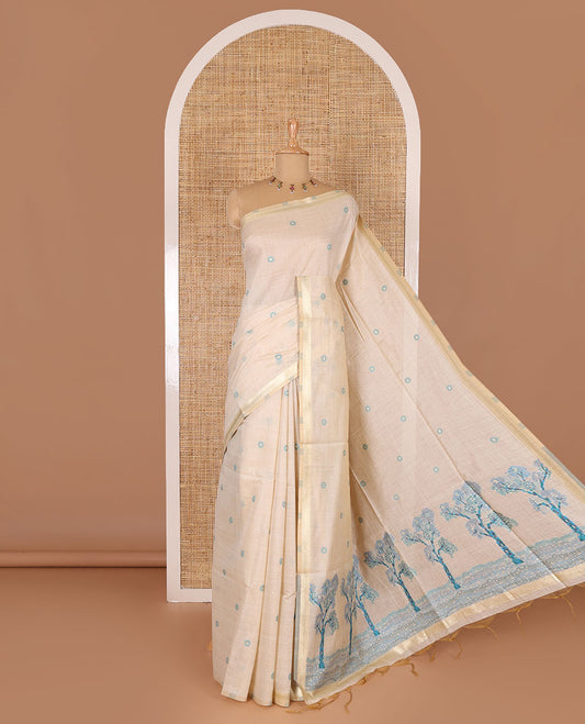 Cream resham thread and zari buttas Munga cotton saree, traditional gold zari border, tree motifs blue thread work pallu, and matching buttas blouse