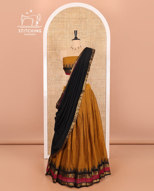 Mustard and Black Chettinad Cotton Half-Saree Featuring a Plain Skirt, Highlighted with a Contrast Traditional Zari Rettai Pettu Temple Border, a Subtly Woven Matching Blouse, and a Vichitra Silk Contrast Traditional Zari-Bordered Dhavani