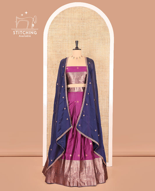 Purple and Navy Blue Semi-Banarasi Half-Saree, Bedecked with Zari Buttas on Its Skirt, Complemented by a Contrast Traditional Zari Designs Woven Border, Paired with a Matching Blouse, and a Contrast Satin Georgette Embroidered Scallop Dhavani