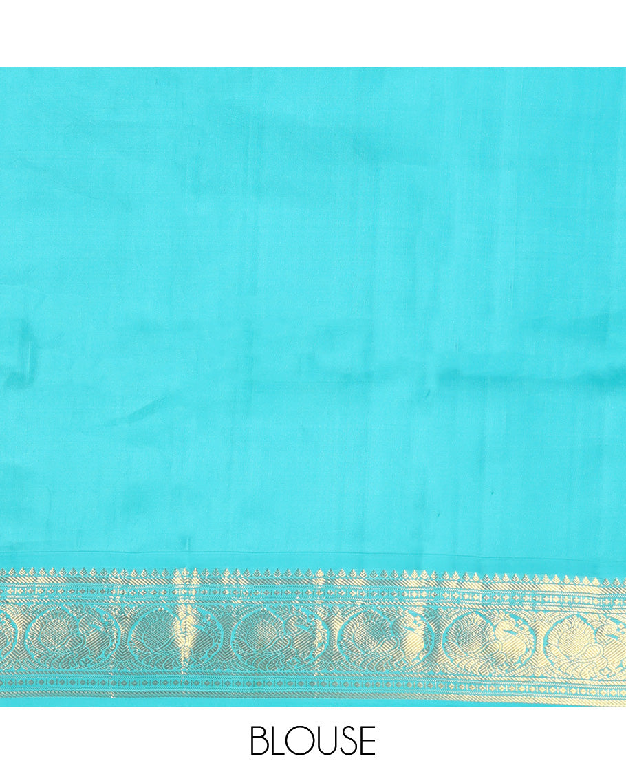 Red Vasundhara Silk Saree, Subtly Sparkled With Zari Buttas All Over Its Body, Complemented by Zari Buttas All Over Its Body, Complemented by Contrast Border of Thilakam, Banaras, and Mayil Designs Grand Jaal Pallu and Paired with a Contrast Blouse