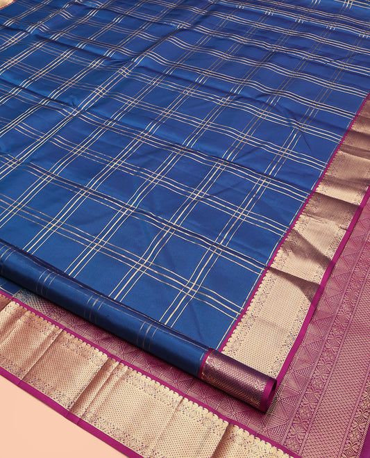 Blue Kanchipuram Silk Saree, Ornamented with Zari Checked Design on Its Body, Complemented by a Contrast Border of Manga, Rekku, Cross Kamalam, and Mayil Kann Designs, Grand Jaal Pallu, and Paired with a Contrast Blouse