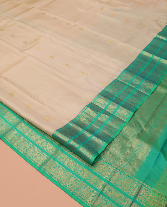 Sandal Vasundhara Silk Saree, Woven with Zari Buttas All Over Its Body, Complemented by a Contrast Border of Jada Nagam, and Kodi Visiry Designs, Intricately Designed Pallu, and Paired with a Contrast Blouse