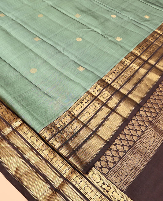 Green Vasundhara Silk Saree, Detailed with Mayil-Chakram Buttas, a Contrast Border of Thikalam, Neli, Kuthirai, Yaanai, Mayil, Chakra, and Mayil Kann, Grand Pallu, and a Contrast Blouse