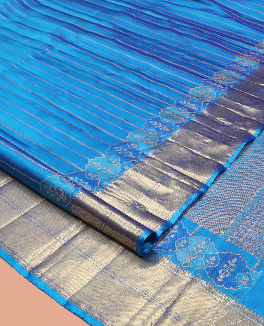 Blue Kanchipuram Designer Silk Saree, Gleamed Up with Zari Stripes, a Zari Border of Thilakam Mokku, Muthu, Rettai Neli, and Kuyil Kann Designs, Intricate Pallu, and a Matching Blouse