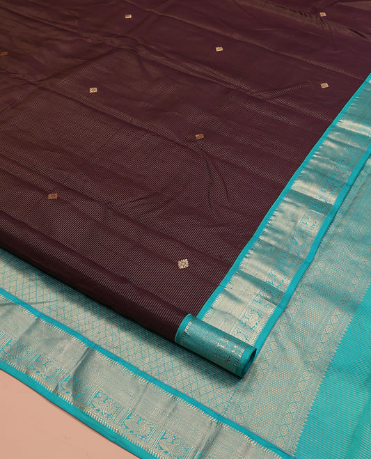 Brown Vasundhara Silk Saree, Charmingly Accented with Stripes and Zari Buttas All Over Its Body, Complemented by a Contrast Border of Rekku, Neli, Kuyil Kann, and Mayil Designs, Grand Jaal Pallu, and Paired with a Contrast Blouse