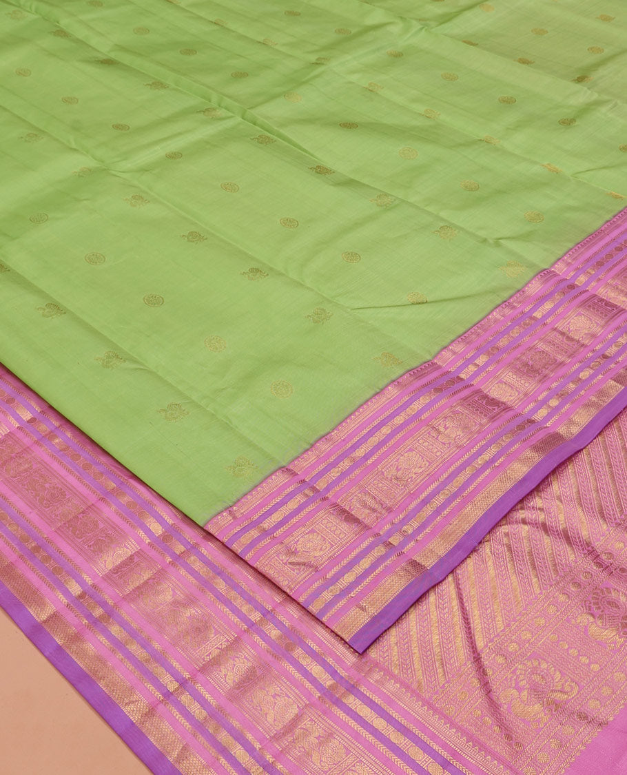 Green Vasundhara Silk Saree, Accentuated with Mayil and Chakram Buttas All Over Its Body, Complemented by a Contrast Border of Rekku, Muthu, Kathir, Poun, Mayil and Mayil Kann Designs, Grand Pallu, and Paired with a Contrast Blouse