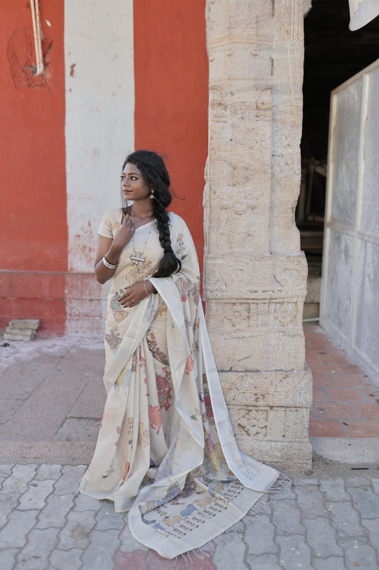 Cream Linen Saree Features Ancient Human Figurines, Floral, and Pichwai Cow, a Zari Border, Kalamkari Pallu, Matching Blouse