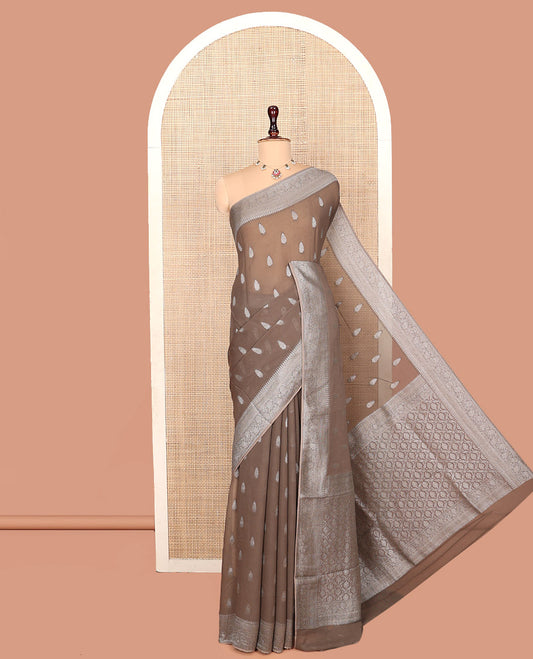 Brown Georgette Saree, Steeped with Buttas, Highlighted by a Traditional Floral Creeper Border, Intricately Designed Pallu, and  a Matching Blouse