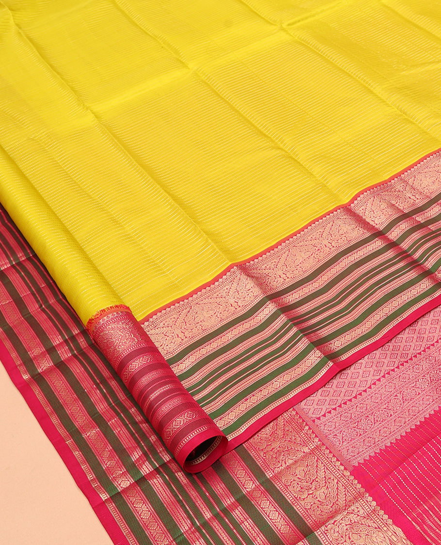Yellow Vasundhara Silk Saree Adorned with Muthu Stripes All Over Its Body, Contrast Border of Thilakam Mokku, Muthu, Banaras, Mayil, Kamalam, and Neli Designs, Intricate Pallu, and Paired with a Contrast Blouse