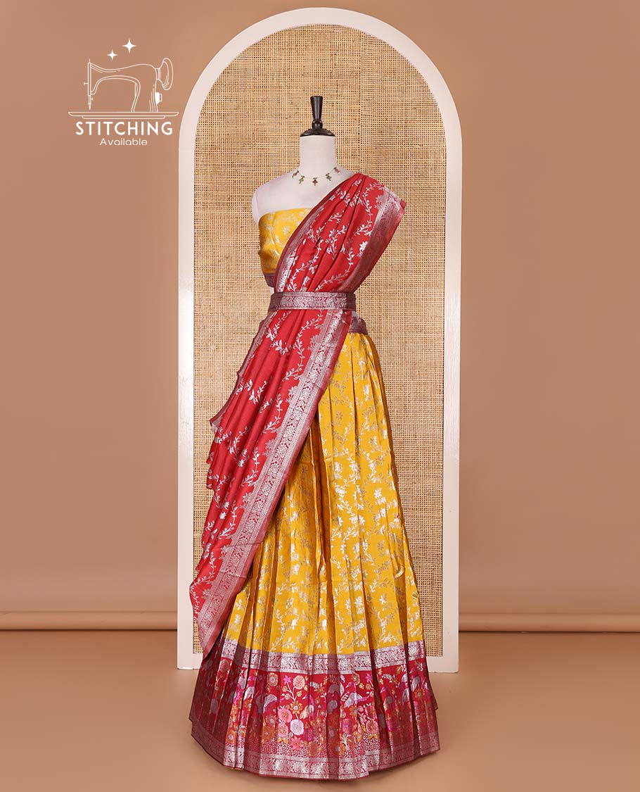 Haldi yellow taffeta silk half saree, floral jaal jacquard skirt, contrast magenta zari meenakari style bird border, matching blouse, and floral jaal dhavani
