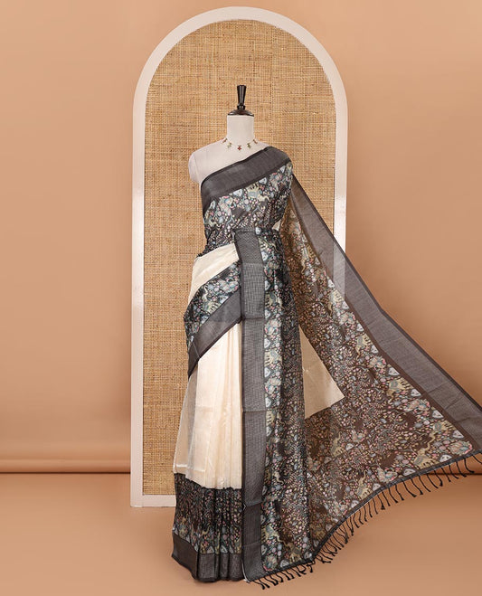 Cream plain tissue saree, contrast dobby-style zari buttas & kalamkari-style flora-fauna printed border & pallu