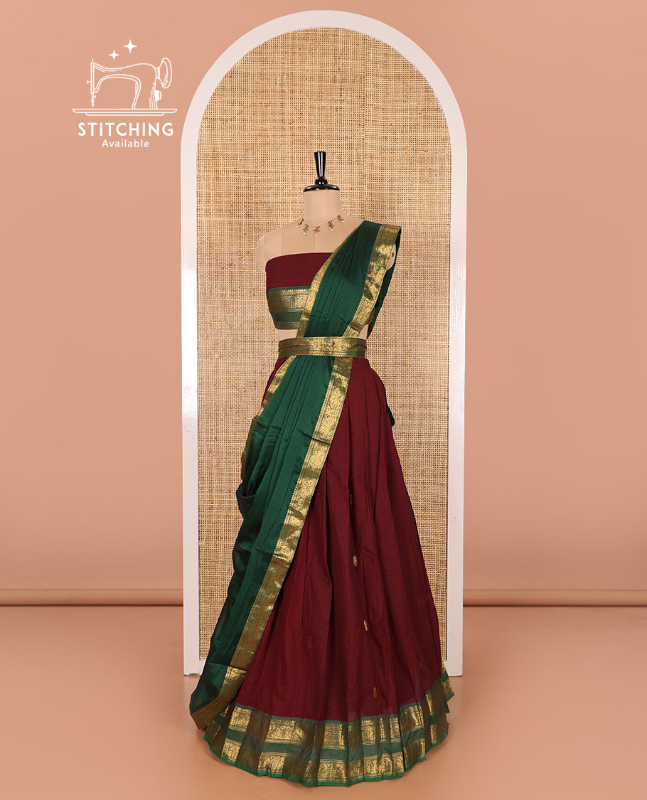 Maroon and Green Chettinad Cotton Half-Saree Featuring Buttas Woven Skirt, Highlighted with a Contrast Rettai Pettu Peacock Motifs Woven Zari Border, a Subtly Woven Matching Blouse, and a Vichitra Silk Contrast Traditional Zari-Bordered Dhavani