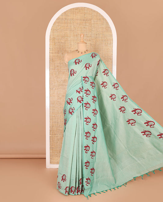 Sea green plain South cotton saree with elephant motifs block printed border, a matching blouse and a contrast floral motifs printed blouse