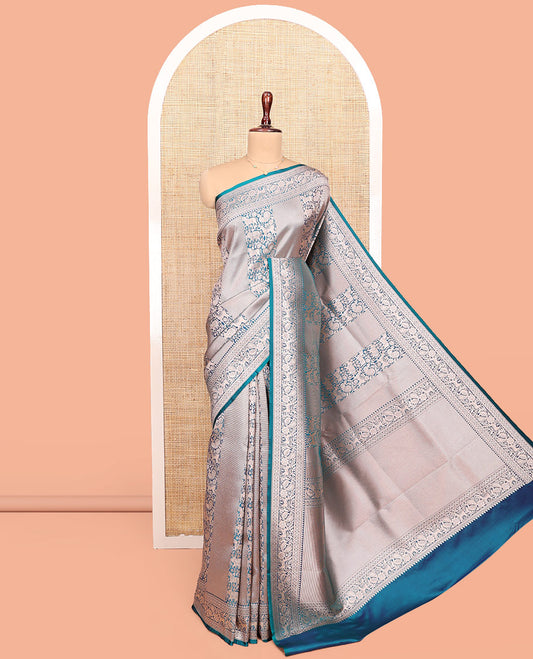 Blue Semi-Banaras Silk Saree, Opulently Embellished with Animal-themed Jacquard Designs on Its Body, Highlighted by a Zari Border of Traditional Designs, Pallu Steeped with Stripes, and Paired with a Matching Blouse