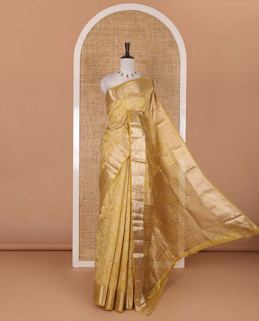 Gold uniquely printed semi-tussar saree, traditional zari border, zari striped pallu, and a matching blouse