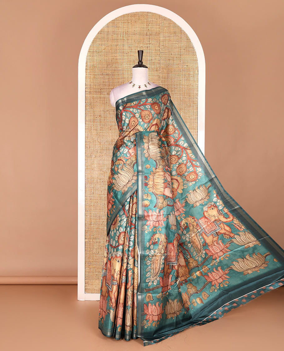 Rama green kalamkari elephant, peacock, and floral printed semi-tussar saree, zari piping border, kalamkari motifs printed pallu, and contrast printed blouse