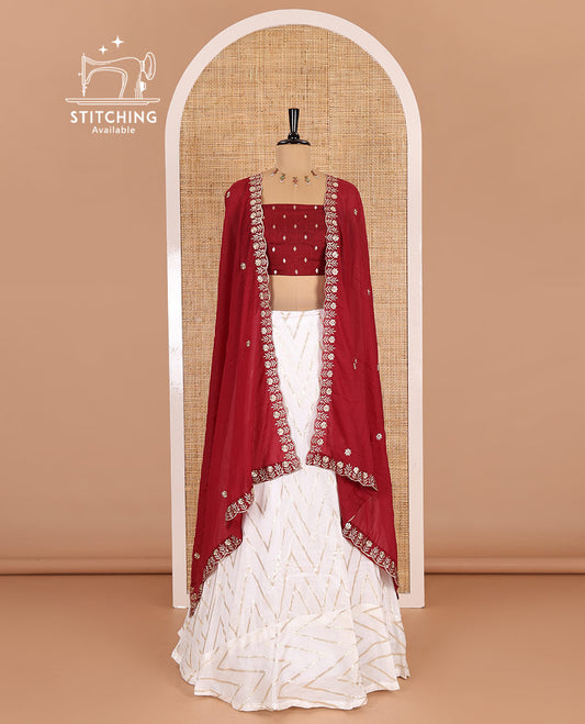 Cream-maroon half-saree, gold chevron striped nylon viscose crepe skirt, contrast diamond buttas blouse, and  a contrast scallop floral-theme embroidered dhavani