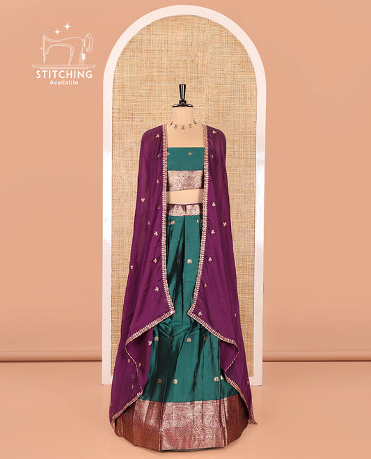 Green and Purple Semi-Banarasi Half-Saree, Adorned with Zari Buttas on Its Skirt, Complemented by a Contrast Traditional Zari Designs Woven Border, Paired with a Matching Blouse, and a Satin Georgette Embroidered Scallop Dhavani