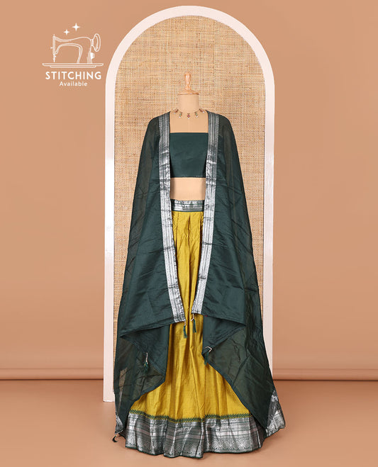Manga yellow taffeta silk half-saree, plain with a contrast traditional design bordered skirt, contrast blouse, and traditional zari bordered blouse
