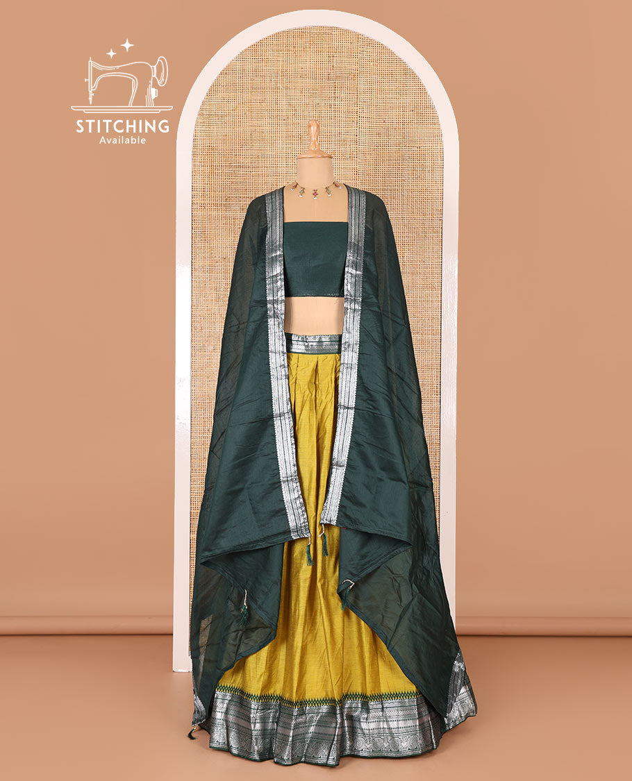 Manga yellow taffeta silk half-saree, plain with a contrast traditional design bordered skirt, contrast blouse, and traditional zari bordered blouse