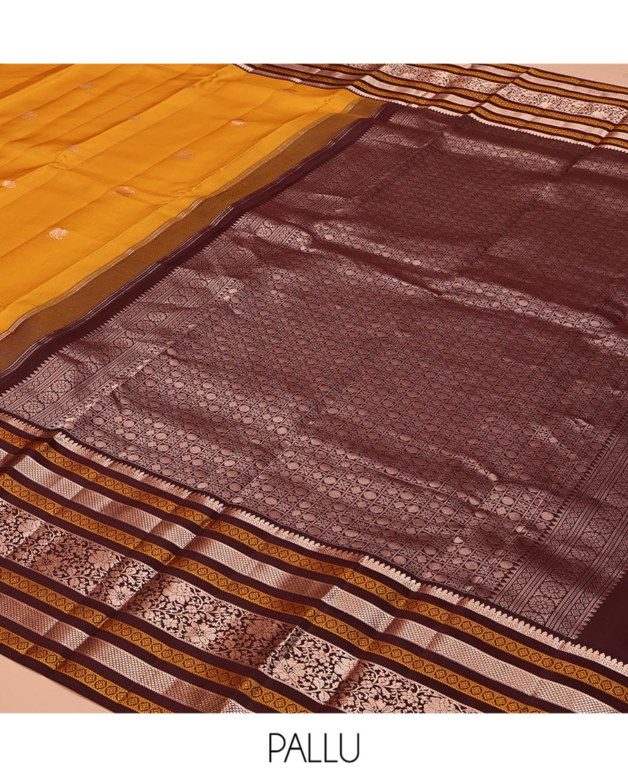 Yellow Vasundhara Silk Saree, Richly Detailed with Zari Buttas All Over Its Body, Complemented by a Contrast Border of Thilakam, Neli, Laddu Kamalam, and Kodi Visiry Designs, Pallu of Butta Enclosed Checks, and Paired with a Contrast Blouse