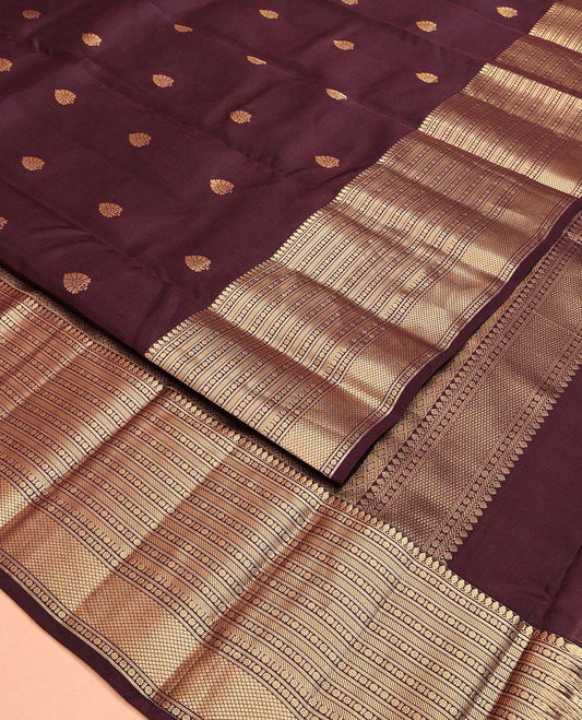 Brown Vasundhara Lite Silk Mix Saree, Ornamented with Zari Buttas All Over Its Body, Highlighted by a Zari Border of Thilakam Mokku, Poun, Kamalam, Banaras, and Mayil Kann Designs, Grand Jaal Design Pallu, and Paired with a Matching Blouse