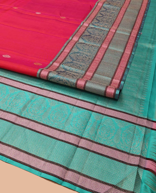 Red Kanchipuram Designer Silk Saree, Subtly Adorned with Buttas All Over Its Body, Complemented by a Captivating Contrast Border of Mughal-Style Designs, Geometric-Patterned Zari-Woven Pallu, and Paired with a Contrast Blouse