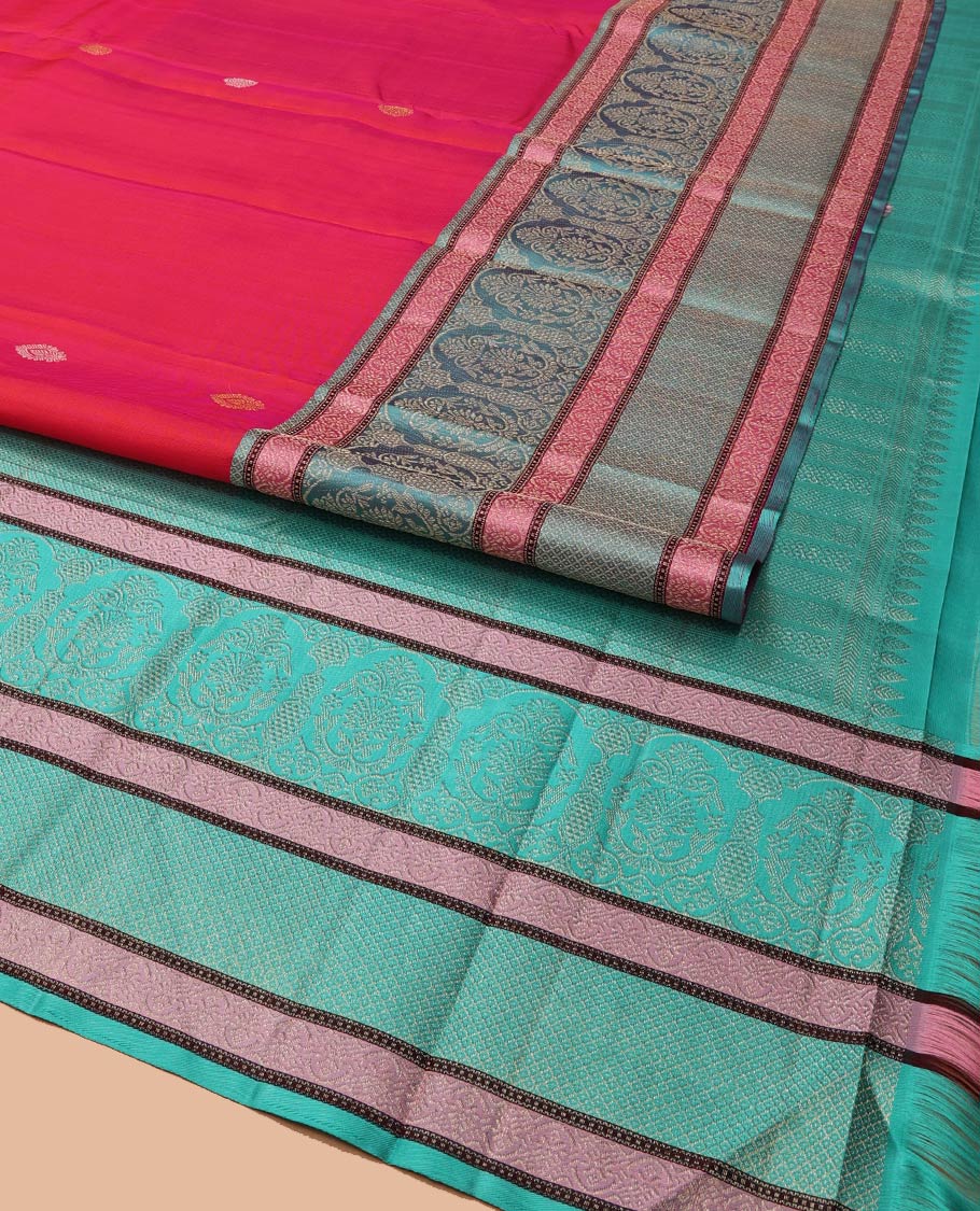 Red Kanchipuram Designer Silk Saree, Subtly Adorned with Buttas All Over Its Body, Complemented by a Captivating Contrast Border of Mughal-Style Designs, Geometric-Patterned Zari-Woven Pallu, and Paired with a Contrast Blouse