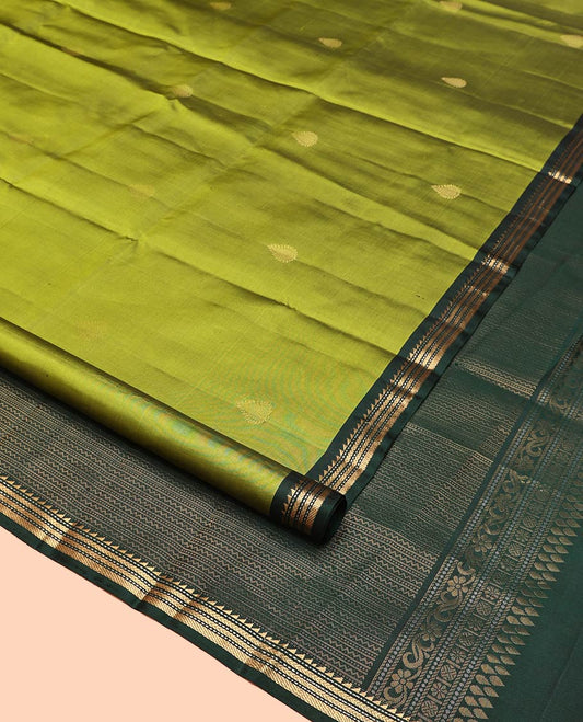 Green Mayuri Soft Silk Saree, Beautifully Bedecked with Zari Buttas All Over Its Body, Complemented by Contrast Border of Ara Bogudi, Muthu, Banaras, and Kathir Designs, Pallu of Neli, Muthu, and Banaras Designs, and Paired with Contrast Blouse
