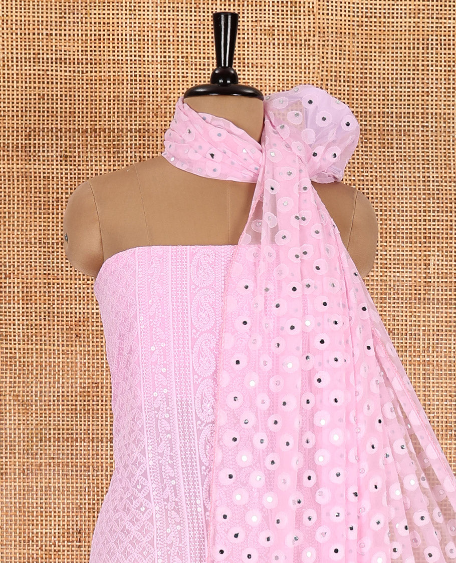 Light pink material chudidar set, paisleys and jaal schiffli sequins embroidered mul georgette top, a matching bottom, and a mirror work dupatta