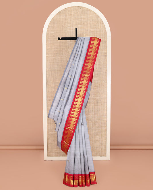 Grey Kanchipuram Silk Saree, Subtly Sparkled with Zari Buttas on Its Body, Complemented by a Contrast One-Sided Korvai Border of Salngai, Banaras, and Jaal Designs, Pallu Features Zari Designs, and Comes Without a Blouse