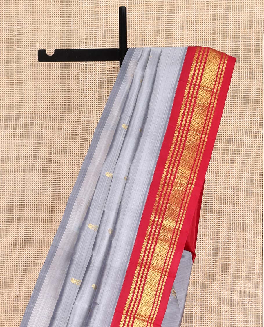 Grey Kanchipuram Silk Saree, Subtly Sparkled with Zari Buttas on Its Body, Complemented by a Contrast One-Sided Korvai Border of Salngai, Banaras, and Jaal Designs, Pallu Features Zari Designs, and Comes Without a Blouse