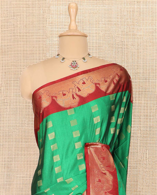 Green Semi-Soft Silk Saree Artfully Detailed with Square-Shaped Buttas Woven All Over Its Body, Complemented by a Contrast Elephant Motifs Zari Border, Pallu Highlighted with Chevron Designs, and Paired with a Contrast Blouse