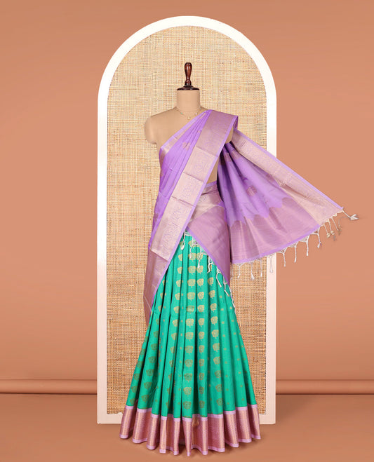 Green Art Silk Material Half Saree Set, Beautified with Zari Buttas and Stripes on Its Skirt, Complemented by a Contrast Traditional Zari Design Border, Paired with a Contrast Blouse, and Intricately Designed Dhavani