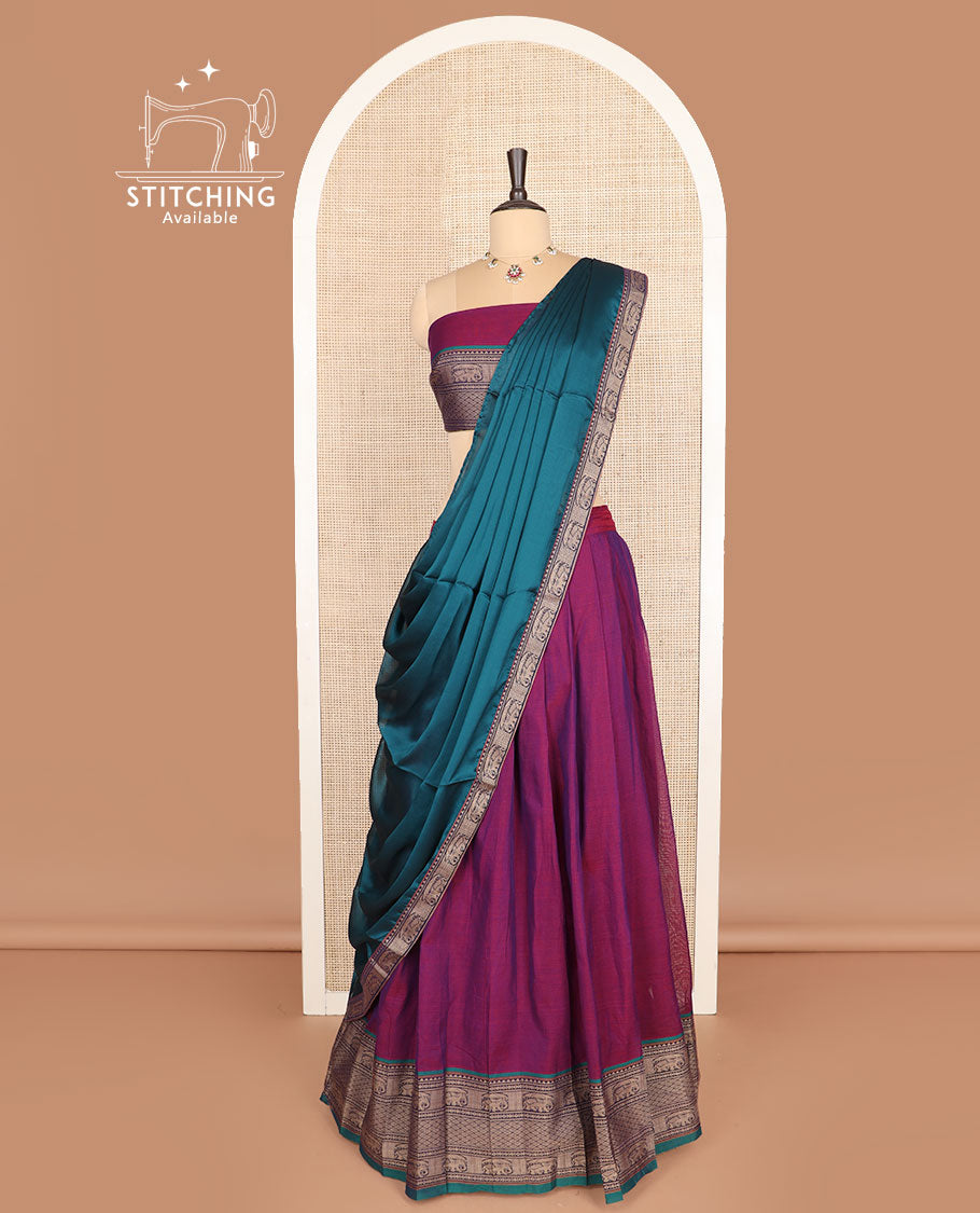 Purple cotton half-saree, plain with contrast traditional border skirt, a matching blouse, and a contrast traditional bordered dhavani