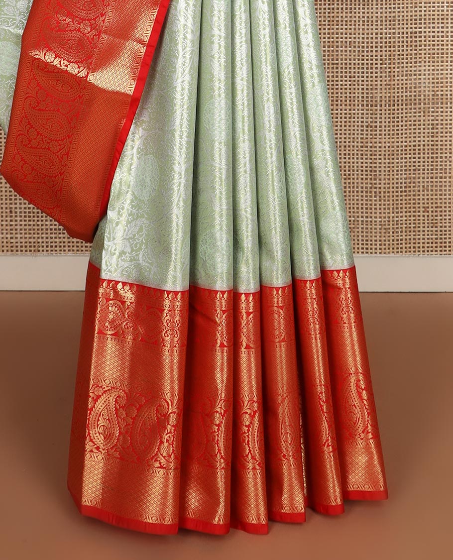 Pastel green floral jaal jacquard budget silk saree, contrast big traditional zari design border, and ogee patterned pallu