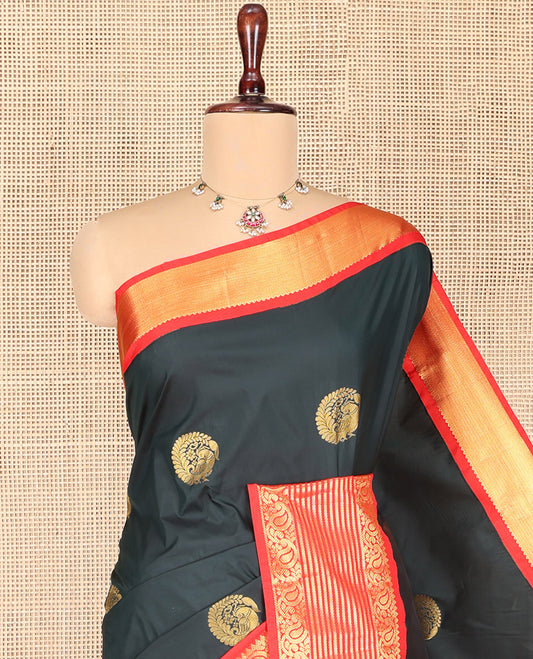 Dark Green Budget Silk Saree, Scintillated with Peacock Zari Buttas All Over Its Body, Complemented by Contrast Border of Paisley Designs, Gleaming Pallu of Jaal Designs, and Paired with a Contrast Blouse