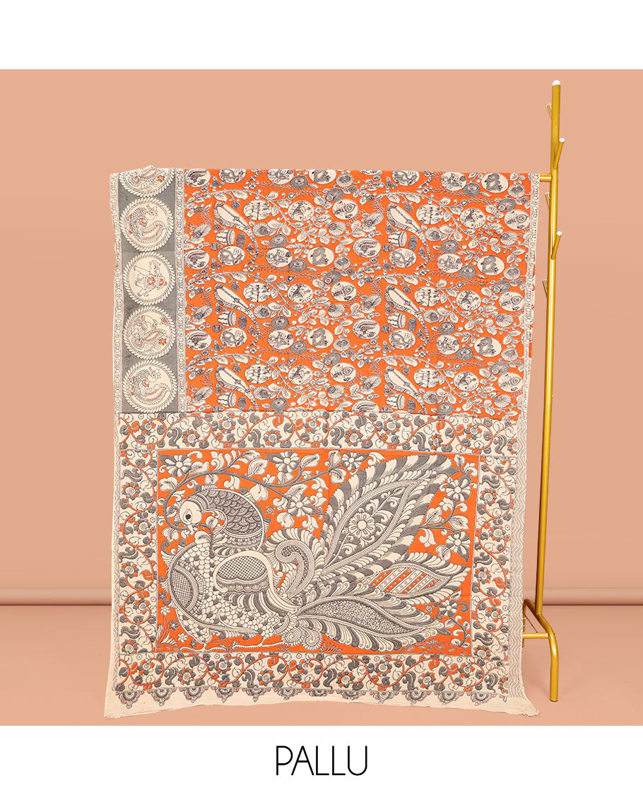 Orange Machine-Printed Kalamkari Cotton Saree, Embellished with Flora, Fauna, and Musical Instrument on Its Body, Complemented by a Contrast Round Motifs Printed Border, Pallu of Kalamakri Peacock Print, and Paired with a Printed Blouse